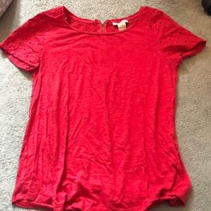 Red short sleeve t-shirt with designs on sleeves